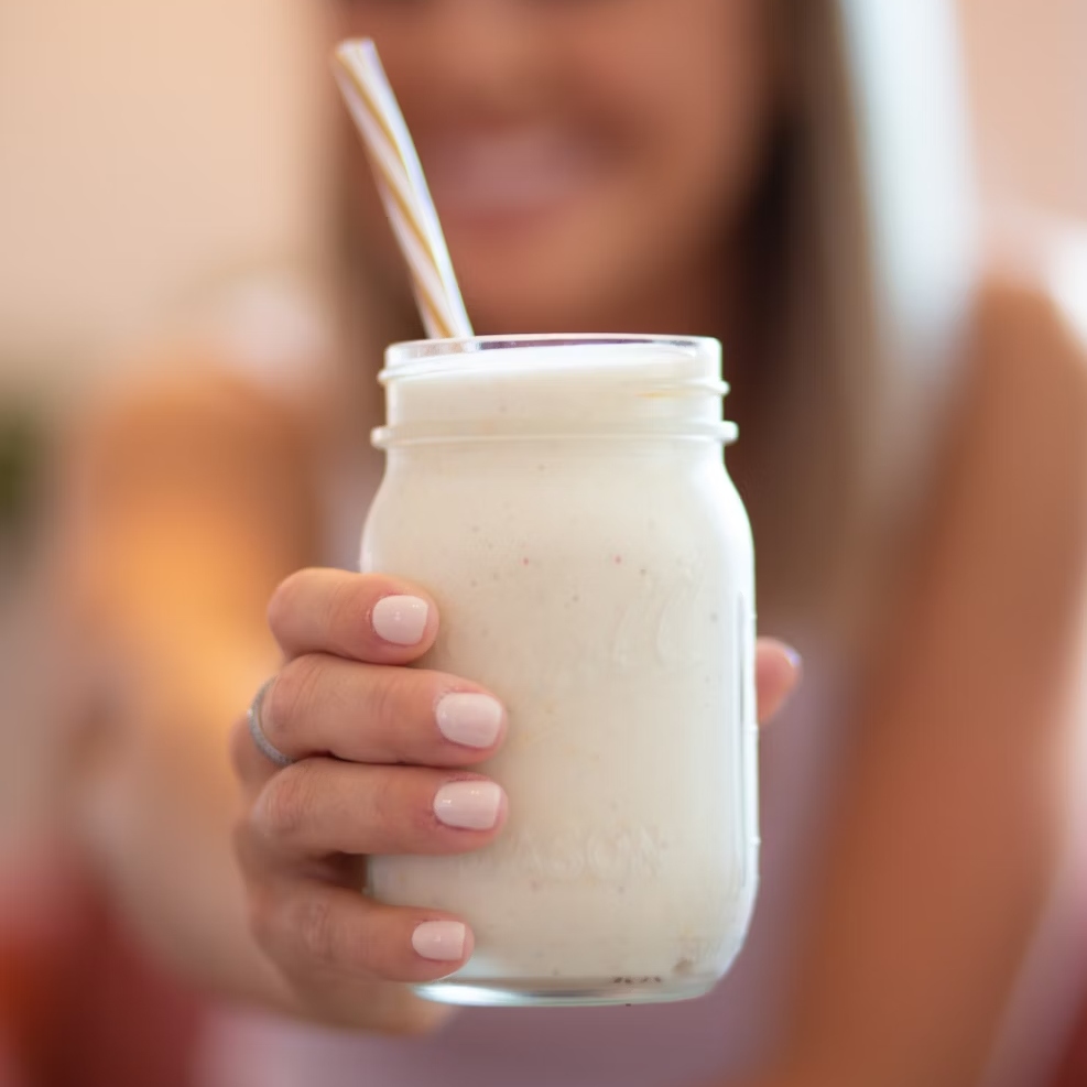 cream colored shake in woman's hand
